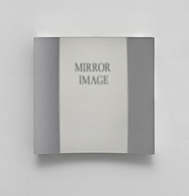 The words "mirror image" are reflected, but not reversed, in this photo of the Hicks non-reversing mirror taken at Robin Cameron's art show. Photo courtesy Room East in New York.